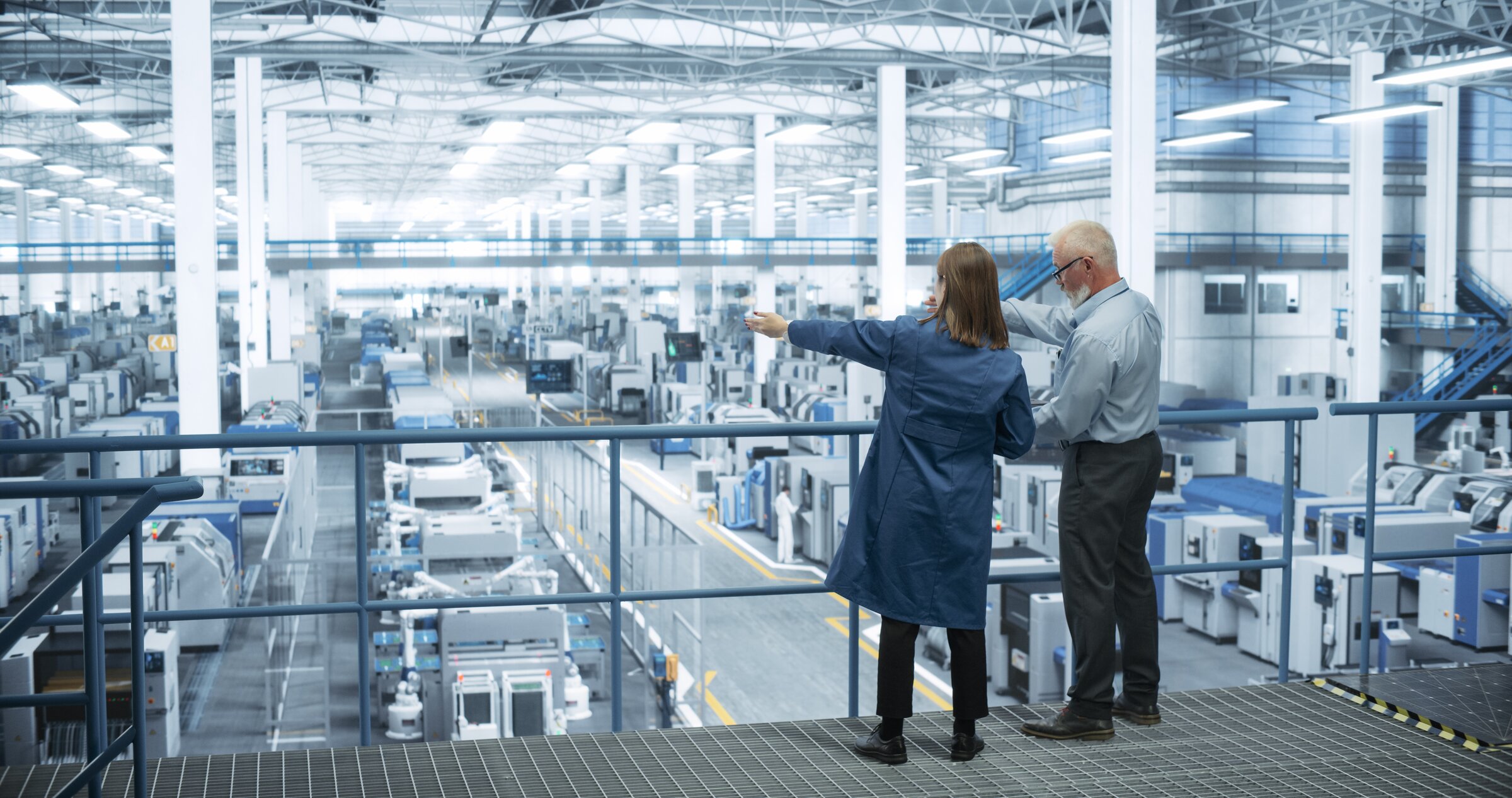 Business owners overseeing manufacturing floor operations